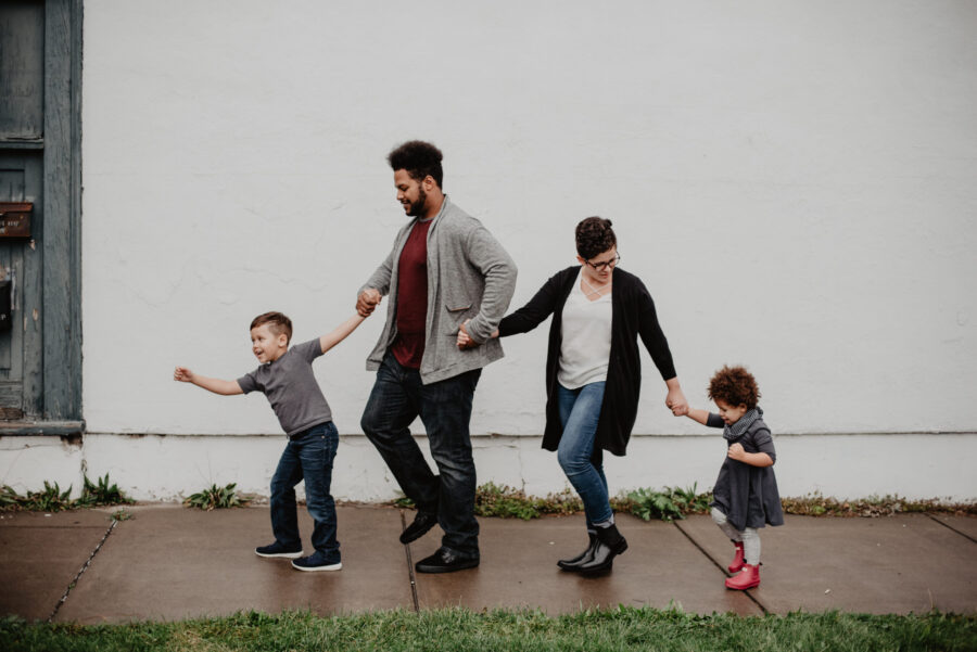 Family of four walking at the street