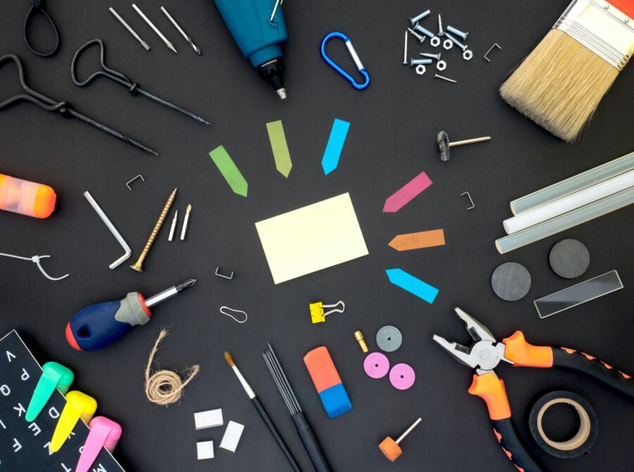 assorted color plastic tools on gray wooden table