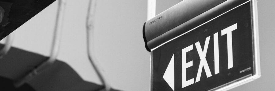 grayscale photo of a black and white arrow sign